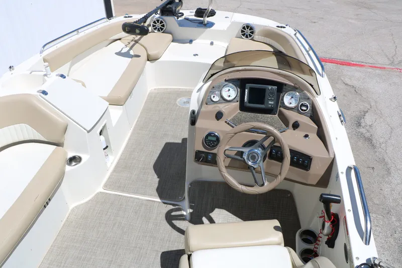 Slide: The Image of Interior view of a 2015 Stingray 192 SC boat with helm console. - 25
