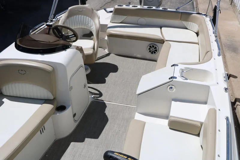 Slide: The Image of Interior of a 2015 Stingray 192 SC boat with beige seating. - 28