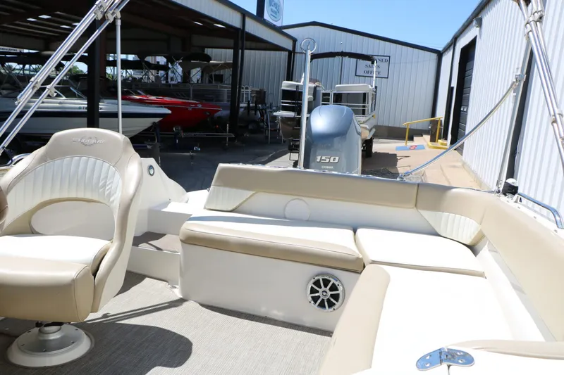 Slide: The Image of Interior of a 2015 Stingray 192 SC boat with beige seating. - 31