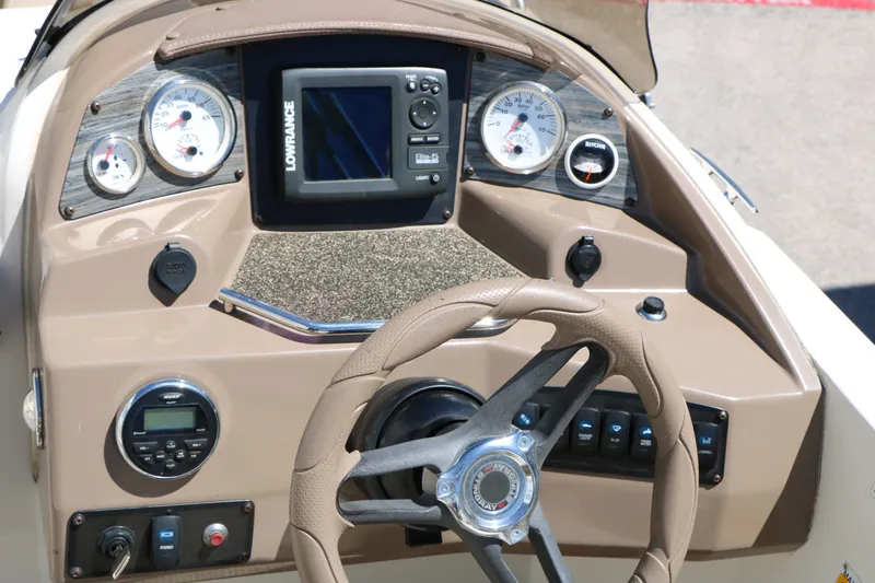Slide: The Image of Dashboard of a 2015 Stingray 192 SC boat with steering wheel and instruments. - 40