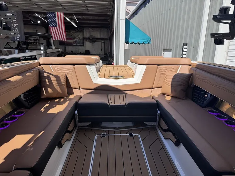 Slide: The Image of Interior of 2026 Nautique Super Air Nautique G25 with brown leather seating. - 10