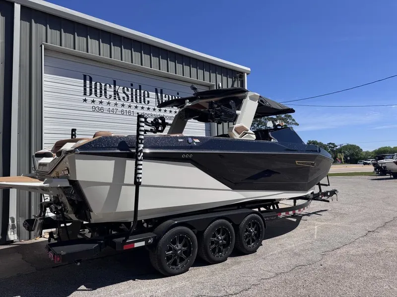 Slide: The Image of 2026 Nautique Super Air Nautique G25 boat on trailer at Dockside Marina. - 17