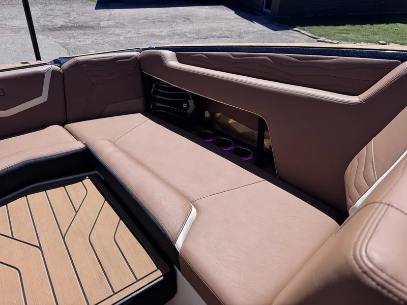 Slide: The Image of Interior of 2026 Nautique Super Air Nautique G25 with brown leather seating. - 7