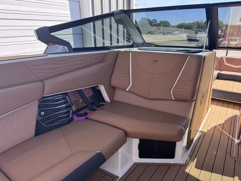 Slide: The Image of Interior of 2026 Nautique Super Air Nautique G25 with brown leather seating. - 8