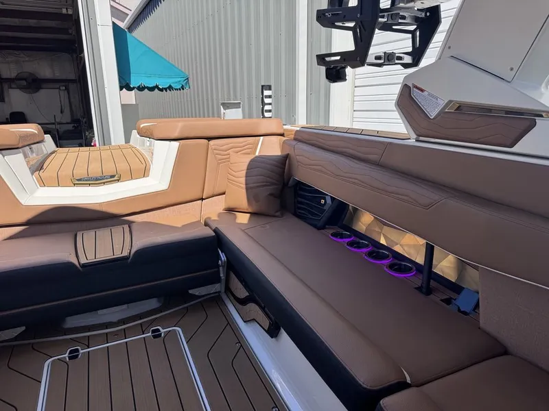 Slide: The Image of Interior of 2026 Nautique Super Air Nautique G25 with brown seating. - 9