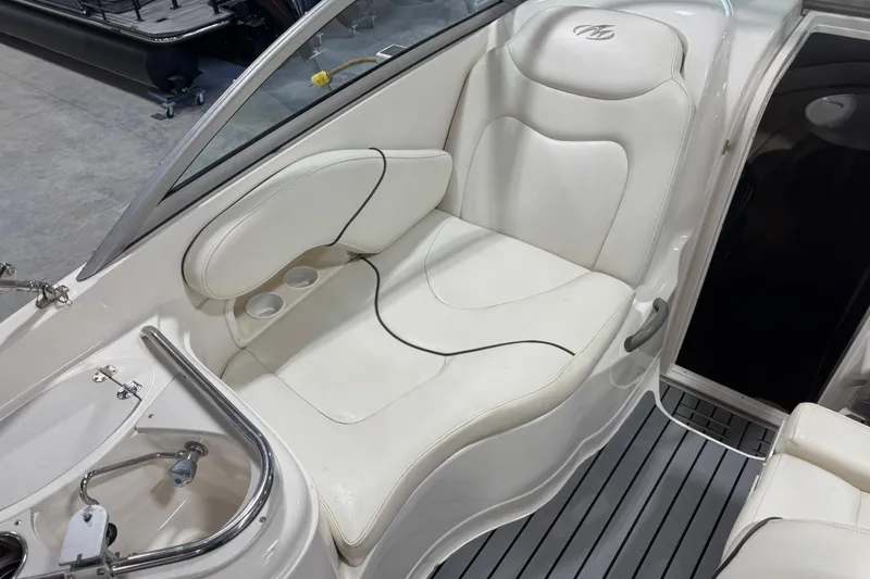 Slide: The Image of Interior seating of a 2005 Monterey 250 Cruiser boat with white upholstery. - 10