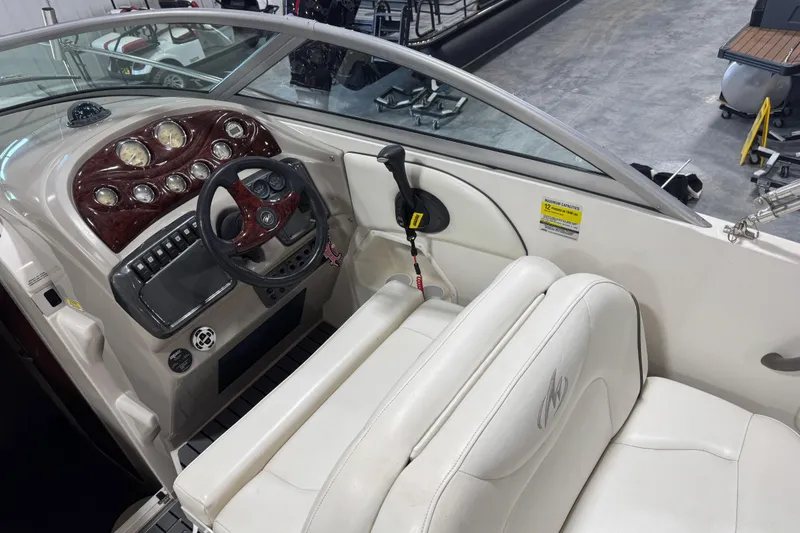 Slide: The Image of Interior view of a 2005 Monterey 250 Cruiser boat cockpit with steering wheel and controls. - 11