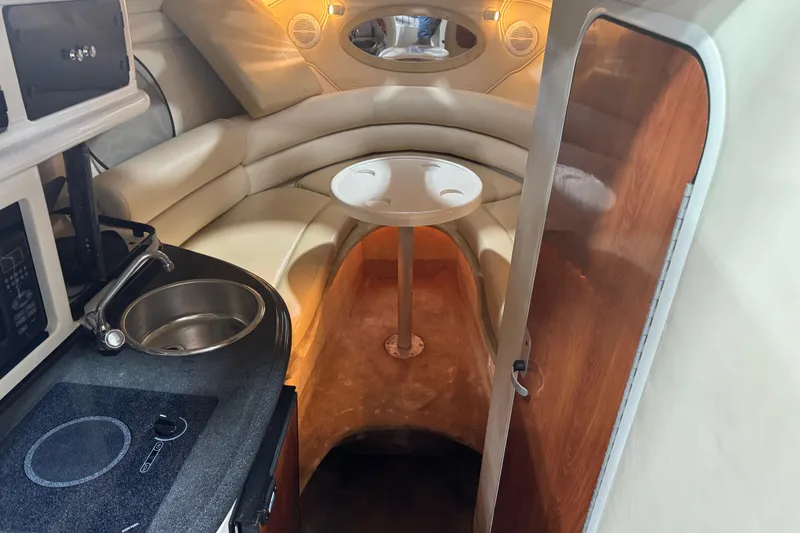 Slide: The Image of Interior of a 2005 Monterey 250 Cruiser boat with kitchenette and seating area. - 13