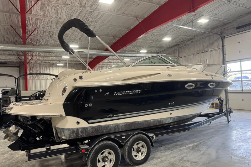 Slide: The Image of 2005 Monterey 250 Cruiser boat on trailer in indoor storage facility. - 3