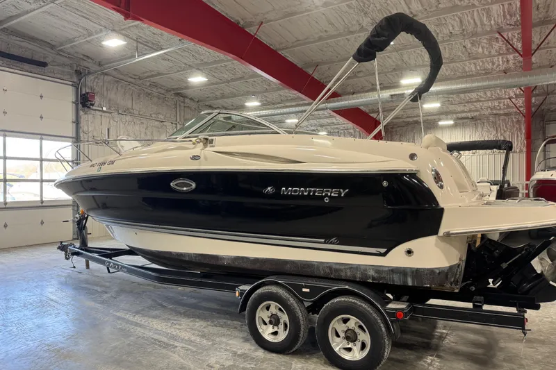 Slide: The Image of 2005 Monterey 250 Cruiser boat on trailer in indoor storage facility. - 4