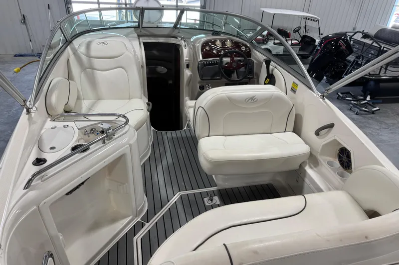 Slide: The Image of 2005 Monterey 250 Cruiser boat interior with white seating and sleek dashboard design. - 6