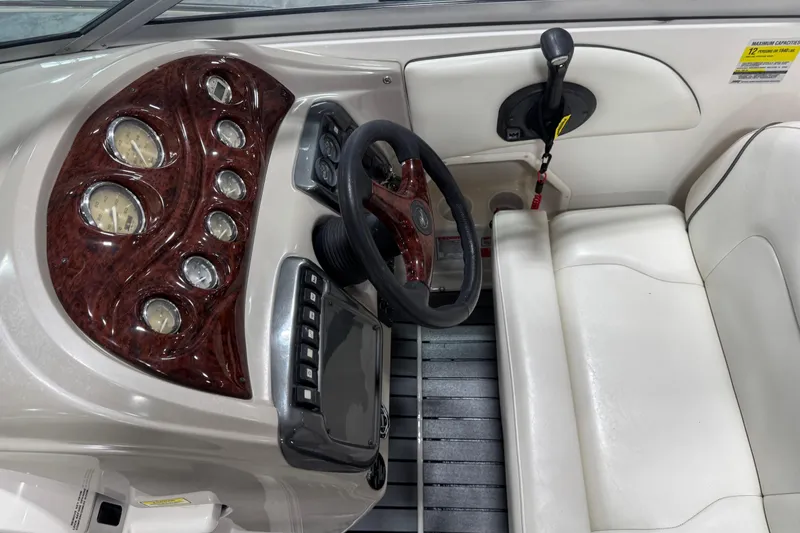 Slide: The Image of 2005 Monterey 250 Cruiser dashboard with wood accents and white seating. - 7