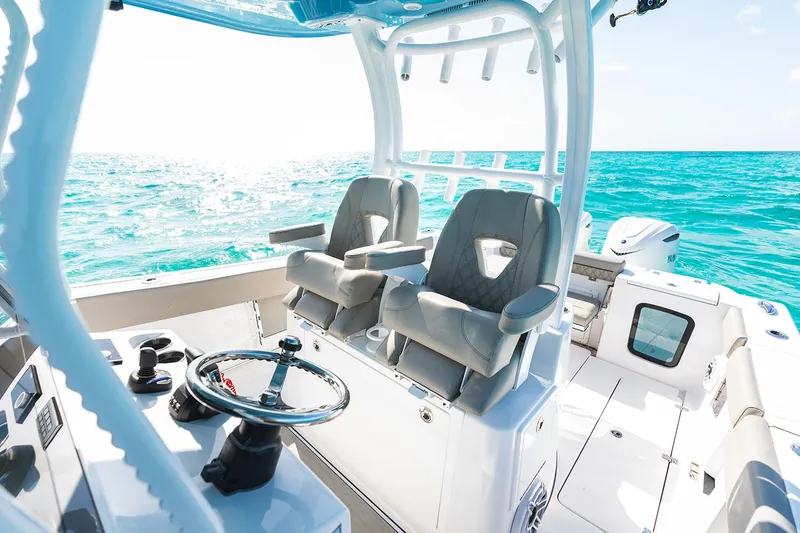 Slide: The Image of Manufacturer Provided Image: 2025 Sportsman Open 302 Center Console boat on turquoise ocean waters. - 7