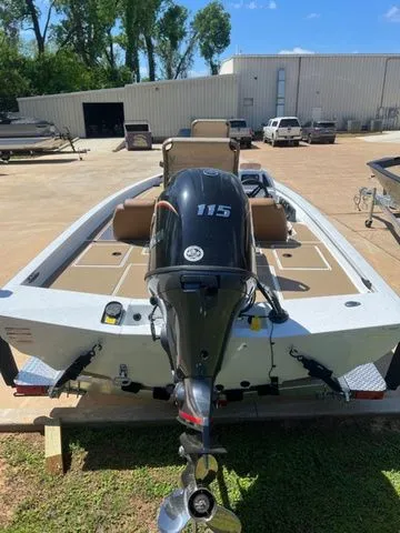 Slide: The Image of 2026 Xpress Boats H18C with outboard motor in parking lot. - 9
