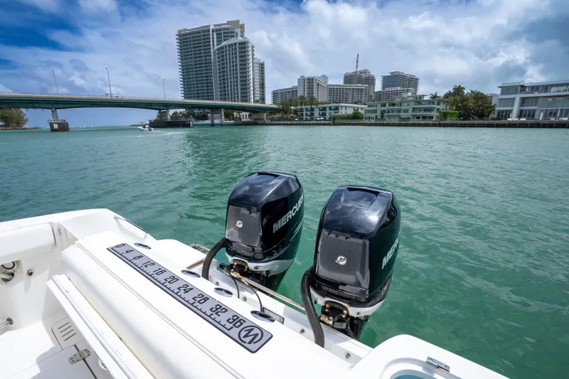 Slide: The Image of Boston Whaler 320 Outrage 2013 with twin Mercury engines on scenic waterfront. - 10