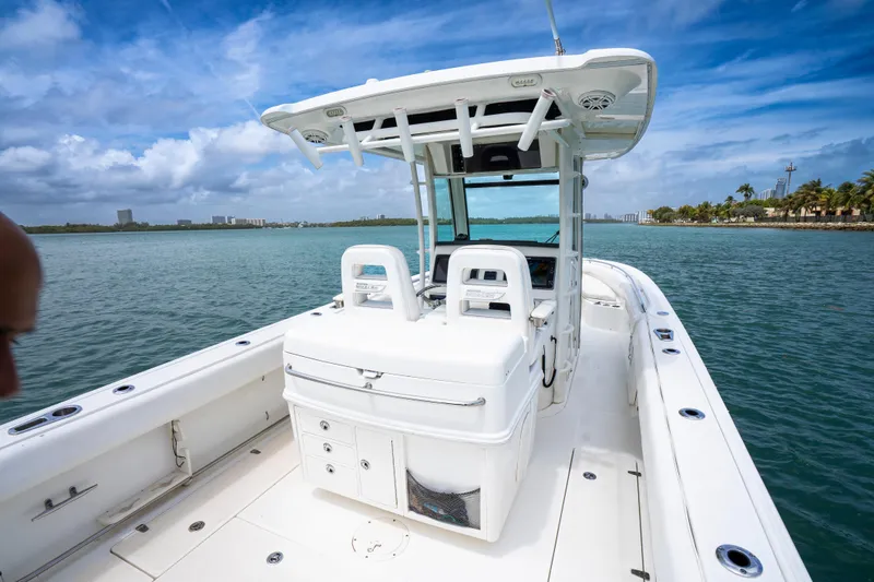 Slide: The Image of 2013 Boston Whaler 320 Outrage boat on calm water under blue sky. - 12