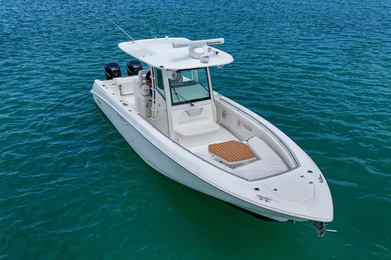 Slide: The Image of 2013 Boston Whaler 320 Outrage boat on clear blue water. - 4
