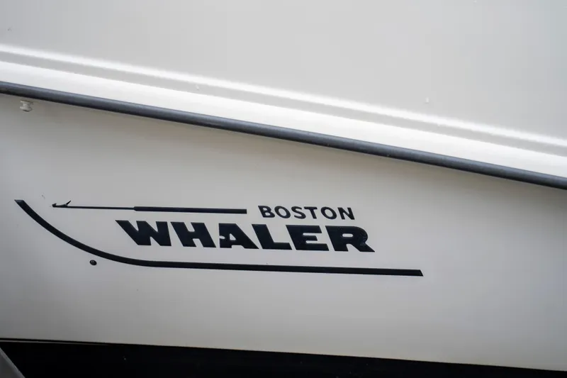Slide: The Image of 2013 Boston Whaler 320 Outrage boat logo on white hull. - 7