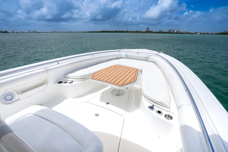 Slide: The Image of Boston Whaler 320 Outrage 2013 boat interior with seating and table on open water. - 8