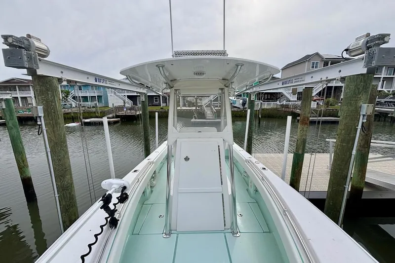 Slide: The Image of 2018 Contender 25 Tournament boat docked at marina, view from bow. - 13