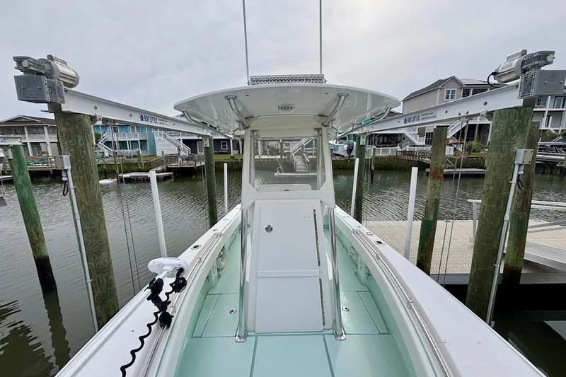 Slide: The Image of 2018 Contender 25 Tournament boat docked at a marina, showcasing its sleek design and spacious deck. - 14