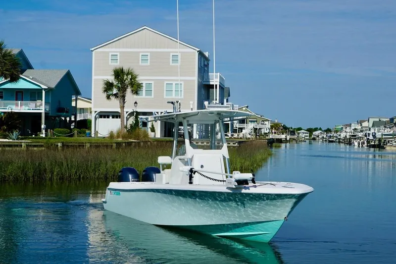 Slide: The Image of 2018 Contender 25 Tournament boat cruising in a scenic residential canal. - 16