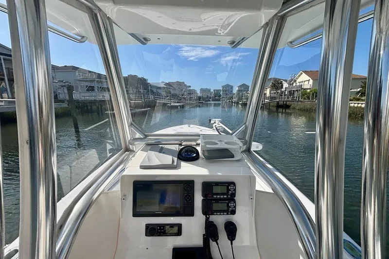 Slide: The Image of Interior view of 2018 Contender 25 Tournament boat, showcasing navigation equipment and waterfront scenery. - 17