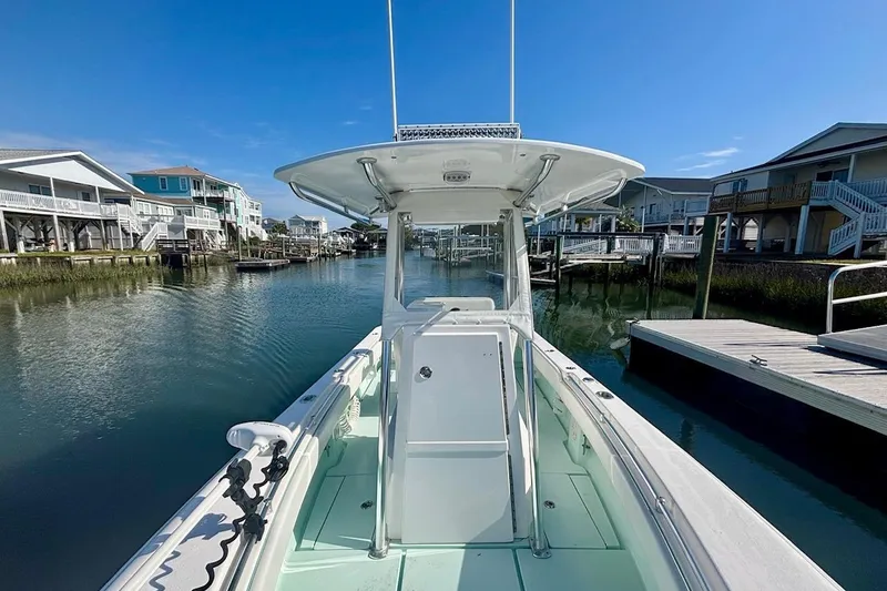 Slide: The Image of 2018 Contender 25 Tournament boat docked in a scenic waterfront neighborhood. - 20