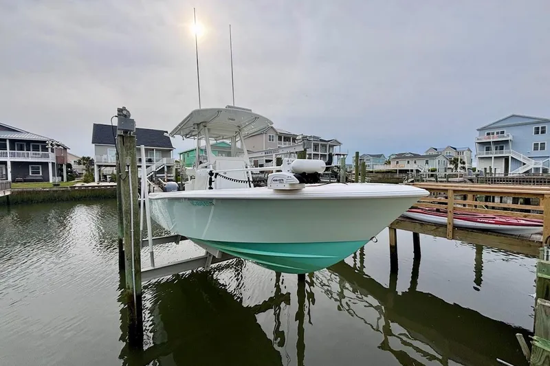 Slide: The Image of 2018 Contender 25 Tournament boat docked in a scenic waterfront neighborhood. - 4