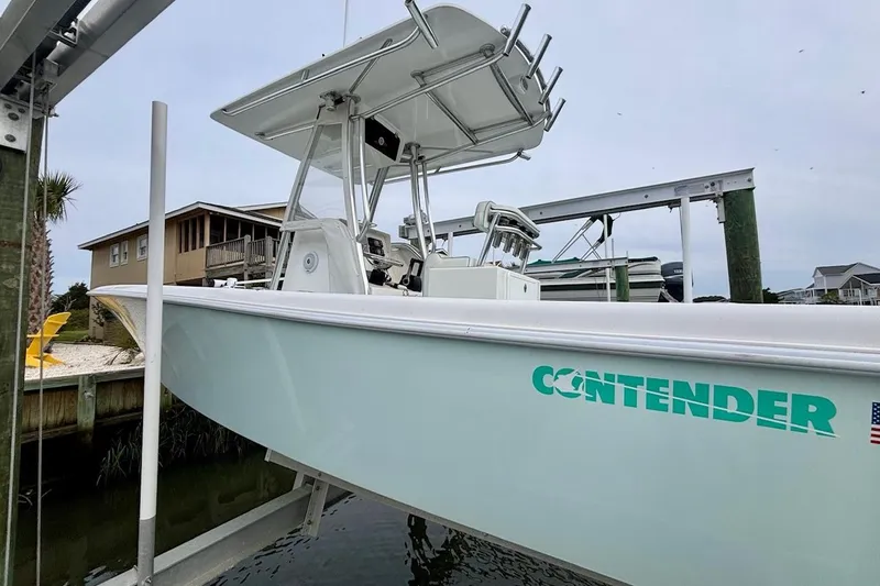 Slide: The Image of 2018 Contender 25 Tournament boat on lift, showcasing sleek design and branding. - 6
