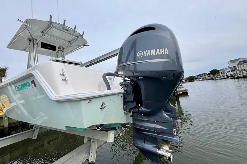 Slide: The Image of 2018 Contender 25 Tournament boat with Yamaha outboard motor, docked by the water. - 7
