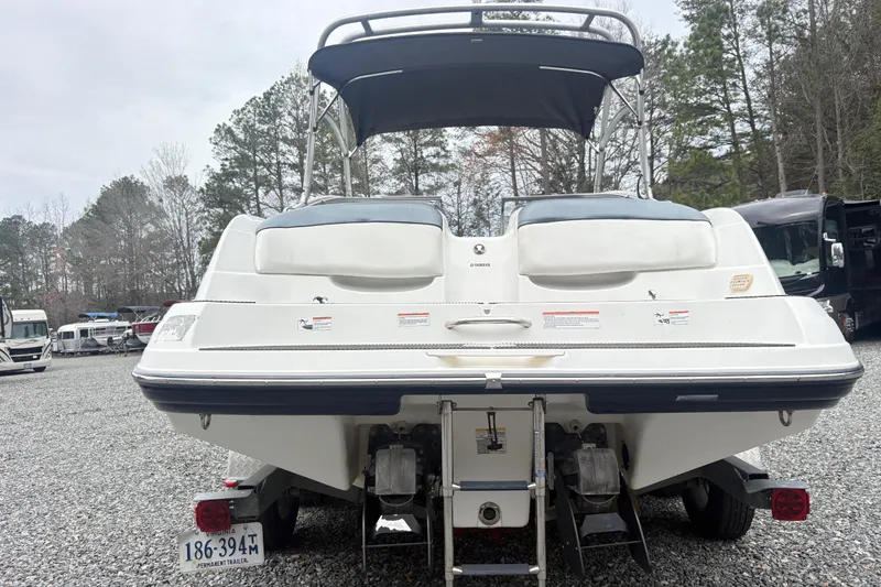 Slide: The Image of 2007 Yamaha AR230 boat rear view with trailer in a gravel lot. - 10