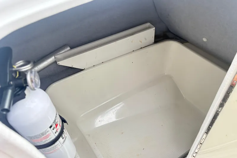 Slide: The Image of Storage compartment in a 2007 Yamaha AR230 boat with a fire extinguisher. - 11