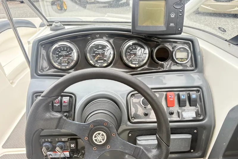 Slide: The Image of Dashboard of a 2007 Yamaha AR230 boat with steering wheel and gauges. - 12