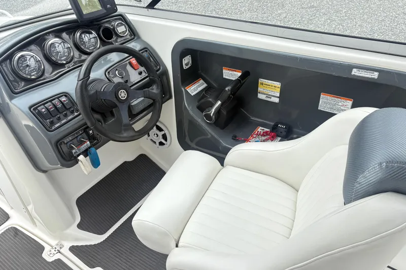 Slide: The Image of 2007 Yamaha AR230 boat cockpit with steering wheel and control panel. - 13