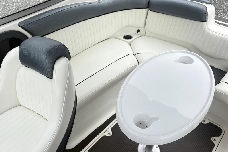 Slide: The Image of 2007 Yamaha AR230 boat interior with white seating and oval table. - 14