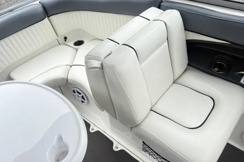 Slide: The Image of 2007 Yamaha AR230 boat interior with white cushioned seating and cup holders. - 15