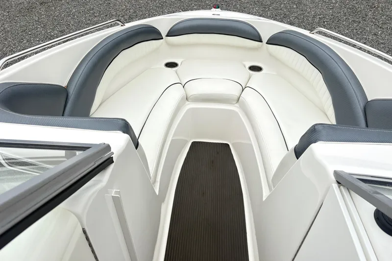 Slide: The Image of 2007 Yamaha AR230 boat interior with white and gray seating, cup holders, and sleek design. - 16