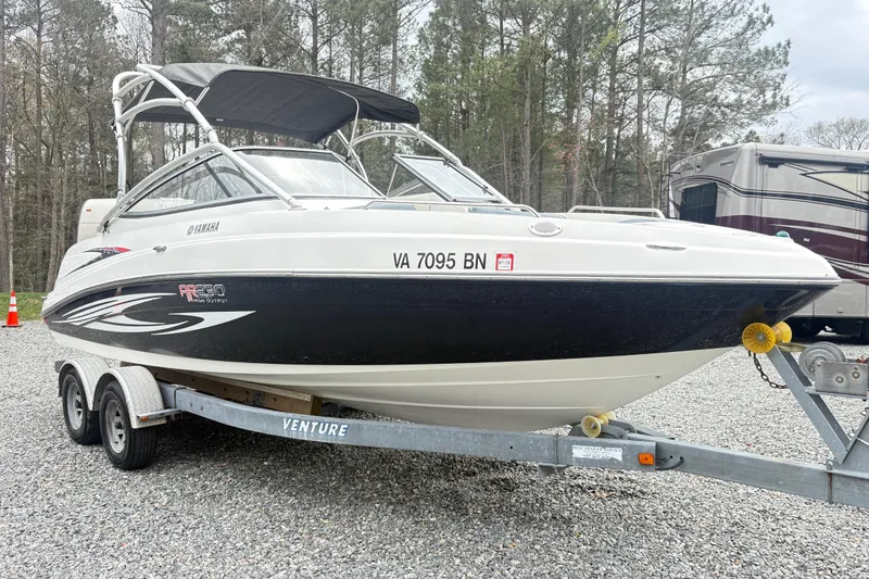 Slide: The Image of 2007 Yamaha AR230 boat on trailer, parked outdoors with trees in background. - 4