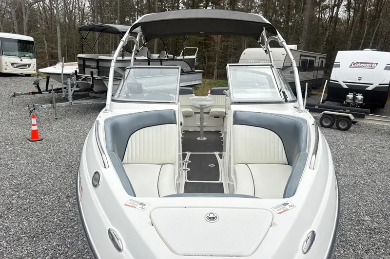 Slide: The Image of 2007 Yamaha AR230 boat with open bow seating, parked among RVs and trailers. - 5