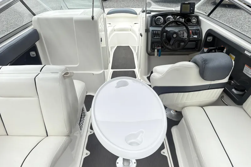 Slide: The Image of 2007 Yamaha AR230 boat interior with steering console, seating, and table. - 6