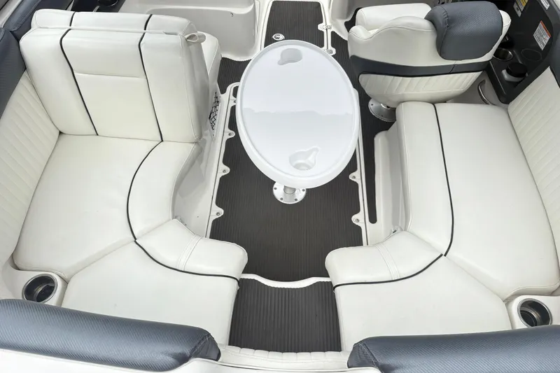 Slide: The Image of 2007 Yamaha AR230 boat interior with white seating and central table. - 7