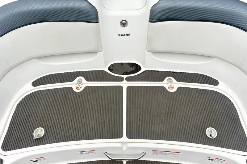 Slide: The Image of 2007 Yamaha AR230 boat deck with gray non-slip surface and white seating. - 9