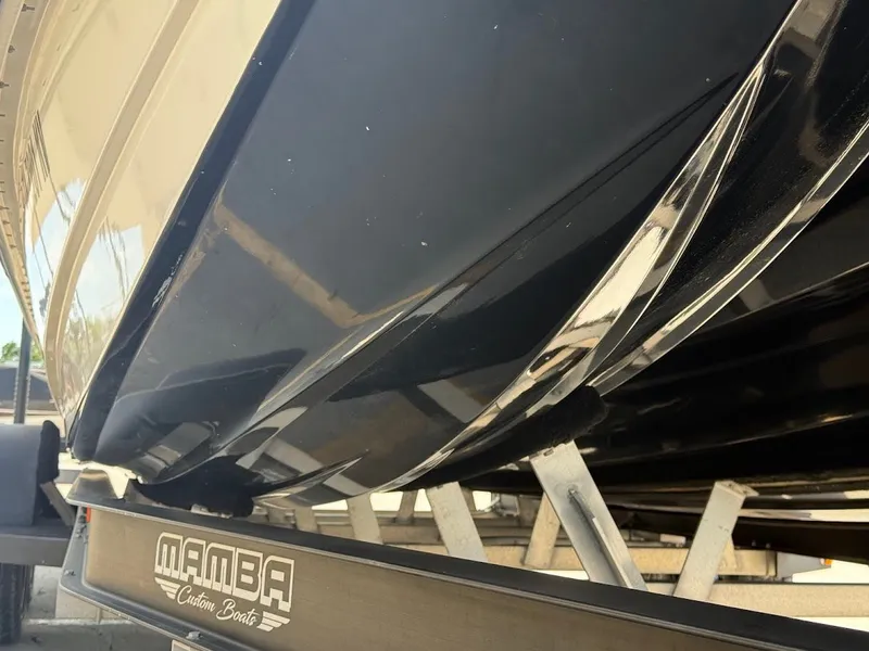 Slide: The Image of Close-up of Mamba 24 Cat Elite boat, year 2025. - 11