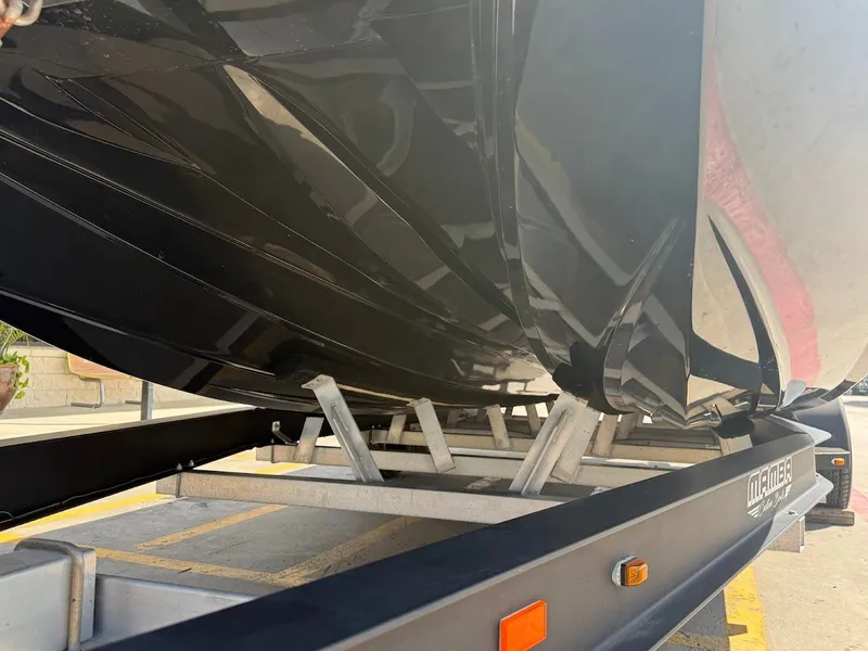 Slide: The Image of Underside of a Mamba 24 Cat Elite boat on a trailer. - 12