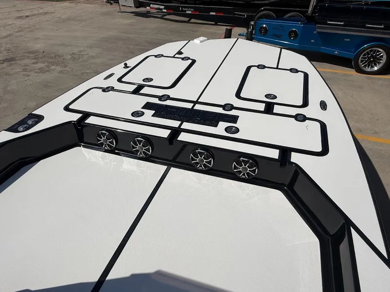 Slide: The Image of Mamba 24 Cat Elite 2025 boat deck with speakers and storage compartments. - 13