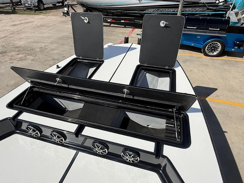 Slide: The Image of Mamba 24 Cat Elite 2025 with open storage compartments and speakers. - 16