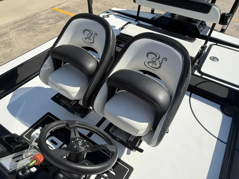 Slide: The Image of Mamba 24 Cat Elite 2025 boat seats and steering wheel. - 24