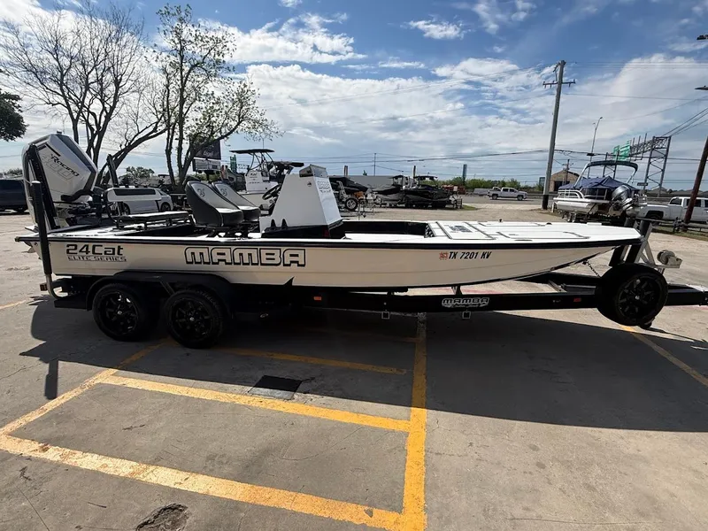 Slide: The Image of 2025 Mamba 24 Cat Elite boat parked on trailer outdoors. - 8