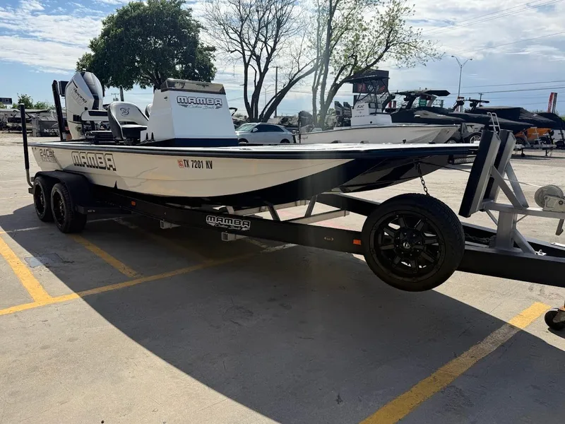 Slide: The Image of 2025 Mamba 24 Cat Elite boat parked on trailer outdoors. - 9